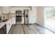 Modern kitchen featuring stainless steel appliances and access to the outdoor deck area at 2868 Oasis Ln, Charlotte, NC 28214