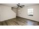 Bright living room featuring wood-look flooring, ceiling fan, and a window allowing natural light at 2868 Oasis Ln, Charlotte, NC 28214