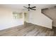 Bright and spacious living room with new floors, modern ceiling fan, and an open floor plan at 2868 Oasis Ln, Charlotte, NC 28214