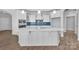 Kitchen features bright white cabinets, a blue tile backsplash, and an expansive center island at 3069 Founding Fathers Dr, Gastonia, NC 28056