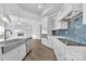 Modern kitchen with white cabinets, stainless steel appliances, and blue backsplash at 3069 Founding Fathers Dr, Gastonia, NC 28056