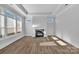 Bright living room with fireplace, tray ceiling, and lots of natural light from large windows at 3069 Founding Fathers Dr, Gastonia, NC 28056