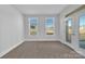 Bright living room featuring two windows and a glass door to the backyard at 3069 Founding Fathers Dr, Gastonia, NC 28056