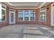 Covered patio featuring brick walls, multiple windows, and ample space for outdoor lounging at 3069 Founding Fathers Dr, Gastonia, NC 28056