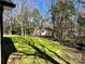 A large grass backyard is filled with mature trees and also features a small shed at 324 Ashford St, Chester, SC 29706