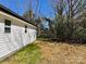 The backyard features grass, trees, and a small shed for storage at 324 Ashford St, Chester, SC 29706