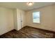 Bright bedroom with wood-look floors, a window, and white trim and walls at 324 Ashford St, Chester, SC 29706