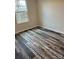 A bright bedroom with a large window and modern flooring, ready for personal touches at 3258 Killian Rd, Lincolnton, NC 28092