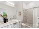 Bright bathroom featuring a large mirror, white cabinets, and a spacious marble-tiled walk-in shower at 3413 Holabird Ln # 10, Charlotte, NC 28208