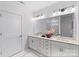 Modern bathroom featuring double sinks, quartz countertops, and decorative floral arrangement at 3413 Holabird Ln # 10, Charlotte, NC 28208