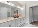 Bright bathroom featuring double sinks and white cabinetry providing ample storage at 3413 Holabird Ln # 10, Charlotte, NC 28208