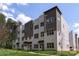 New construction townhomes boast modern exteriors, symmetrical window design, and manicured landscaping at 3413 Holabird Ln # 10, Charlotte, NC 28208