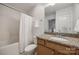 Well-lit bathroom featuring granite counters, tiled floors, and shower-tub combination at 423 Castlebury Ct, Clover, SC 29710