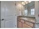 Bathroom featuring granite countertop, wood cabinets, towel rack and square window at 423 Castlebury Ct, Clover, SC 29710