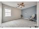 Comfortable bedroom with ceiling fan, neutral carpet, and soothing two-tone paint scheme at 423 Castlebury Ct, Clover, SC 29710