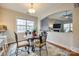 Cozy dining area with elegant chandelier, table and chairs next to living room at 423 Castlebury Ct, Clover, SC 29710