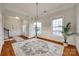 Bright dining room with hardwood floors, large windows, and adjacent access to the foyer at 423 Castlebury Ct, Clover, SC 29710