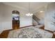 Open dining room with hardwood floors, decorative lighting, and seamless access to the kitchen and foyer at 423 Castlebury Ct, Clover, SC 29710