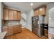 Spacious kitchen boasts stainless steel appliances, wooden cabinets, and hardwood floors at 423 Castlebury Ct, Clover, SC 29710