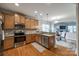 Modern kitchen featuring stainless steel appliances, wooden cabinets, and an open layout to the dining area at 423 Castlebury Ct, Clover, SC 29710