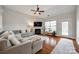 Comfortable living room with fireplace, large windows, neutral tones, and hardwood flooring at 423 Castlebury Ct, Clover, SC 29710