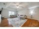 Spacious living room featuring tray ceilings, hardwood floors, recessed lighting, and a ceiling fan at 423 Castlebury Ct, Clover, SC 29710