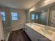 Modern bathroom featuring double vanity, large mirror, tiled floors, and a glass-enclosed shower at 4254 Black Ct # 170, Harrisburg, NC 28075