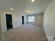 Bright, carpeted bonus room featuring recessed lights and a large window at 4254 Black Ct # 170, Harrisburg, NC 28075