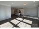 Open-concept living area with hardwood floors and a view into the modern kitchen at 4254 Black Ct # 170, Harrisburg, NC 28075