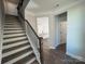 Elegant staircase with dark wood treads and iron railing, leading to the upper level at 4254 Black Ct # 170, Harrisburg, NC 28075