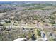 The aerial view shows a beautiful community surrounded by woodlands and rolling hills at 4450 Flowes Store Rd, Concord, NC 28025