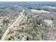 The aerial perspective shows a vibrant community surrounded by natural woodlands and green landscapes at 4450 Flowes Store Rd, Concord, NC 28025