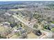 The aerial view shows a diverse landscape with woodlands, meadows, and residential areas at 4450 Flowes Store Rd, Concord, NC 28025