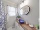 Modern bathroom with vessel sink, elegant mirror, and shower with patterned curtain at 4450 Flowes Store Rd, Concord, NC 28025