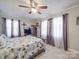 Inviting bedroom featuring a bed with floral pattern bedding and soft natural light at 4450 Flowes Store Rd, Concord, NC 28025