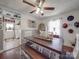 Inviting dining room with hardwood floors, bench seating, and an easy connection to the kitchen at 4450 Flowes Store Rd, Concord, NC 28025