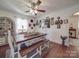 Charming dining room with a ceiling fan, hardwood floors and a large wooden table with bench seating at 4450 Flowes Store Rd, Concord, NC 28025