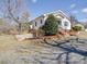 Single-story home with brick foundation, landscaping, and driveway at 4450 Flowes Store Rd, Concord, NC 28025