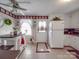 Bright kitchen featuring tile floors, white cabinets, and modern appliances, complemented by decor at 4450 Flowes Store Rd, Concord, NC 28025