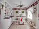 Bright kitchen featuring tile floors, white cabinets, and modern appliances, complemented by decor at 4450 Flowes Store Rd, Concord, NC 28025