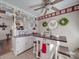 Bright kitchen featuring tile floors, white cabinets, and modern appliances, complemented by decor at 4450 Flowes Store Rd, Concord, NC 28025