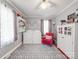 Bright laundry area with a washer, dryer, storage, and a cozy red armchair at 4450 Flowes Store Rd, Concord, NC 28025