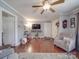 Open living area with hardwood floors, a decorative ceiling, and neutral walls for decor versatility at 4450 Flowes Store Rd, Concord, NC 28025