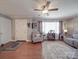 Comfortable living room with hardwood floors, a gray accent chair, and a well-lit front entry at 4450 Flowes Store Rd, Concord, NC 28025