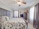 Charming main bedroom featuring wood accents, soft textures, and a ceiling fan for added comfort at 4450 Flowes Store Rd, Concord, NC 28025