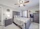 Charming main bedroom featuring wood accents, soft textures, and a ceiling fan for added comfort at 4450 Flowes Store Rd, Concord, NC 28025