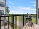 Outdoor balcony with black metal railings, barbecue grill, and tree top views at 5003 Tiny Ln, Charlotte, NC 28203