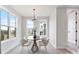 Bright dining room features a modern table with seating, ample natural light, and a minimalist design at 5003 Tiny Ln, Charlotte, NC 28203