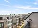 View of the modern townhome community with rooftop terraces and beautiful blue sky at 5003 Tiny Ln, Charlotte, NC 28203