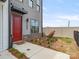 Charming townhouse with a vibrant red door, brick foundation, and tidy landscaping for a welcoming entrance at 5003 Tiny Ln, Charlotte, NC 28203